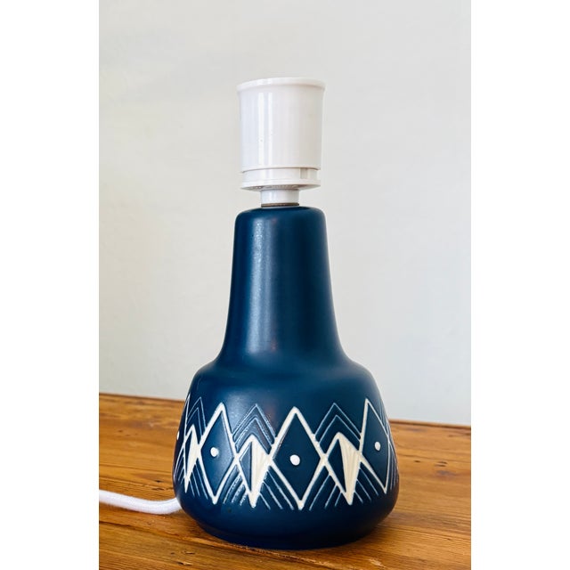 Søholm stoneware table lamp featuring a deep cobalt blue matte glaze with a white decorative pattern around the base. An...