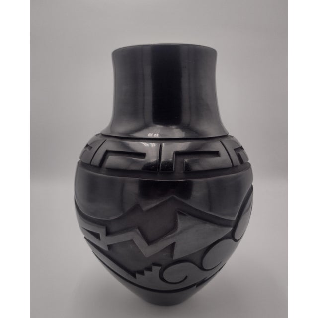 A magnificent hand-coiled Santa Clara Pueblo blackware vase by acclaimed Pueblo potter Sherry Tafoya, beautifully executed...