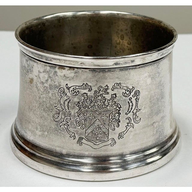 Vintage wine bottle coaster engraved with a heraldic crest or coat of arms on two sides. Patina to metal. There is a...