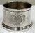 Vintage wine bottle coaster engraved with a heraldic crest or coat of arms on two sides. Patina to metal. There is a...