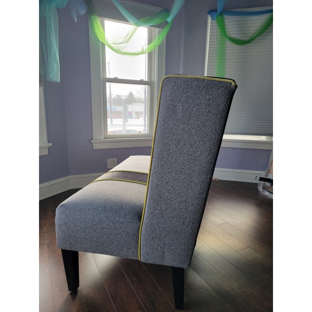 this armless high back bench has been transformed with a bold oversized leaf pattern in black, cream, gray, and chartreuse...