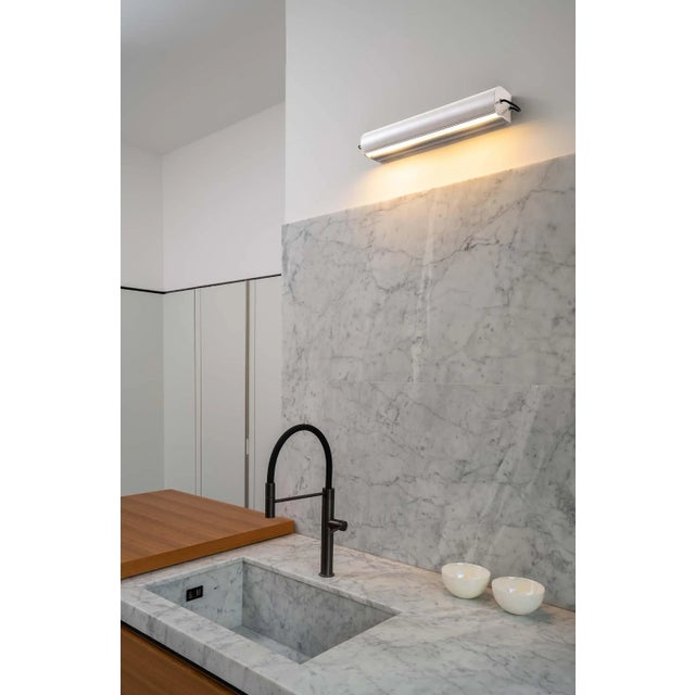 Charlotte Perriand 'Applique Cylindrique Longue' wall lamp in light blue. Perriand's iconic 'Applique Cylindrique'...