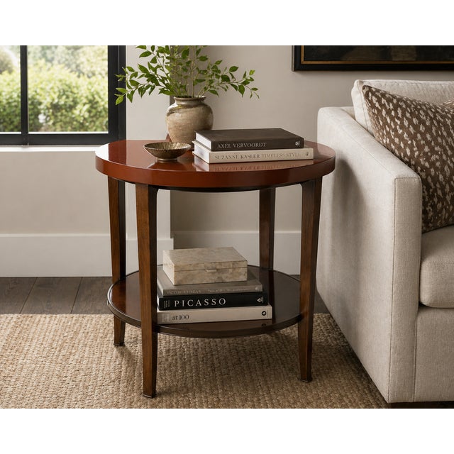 A refined round side table designed by Bill Sofield for Baker Furniture, showcasing a clean, architectural silhouette with...