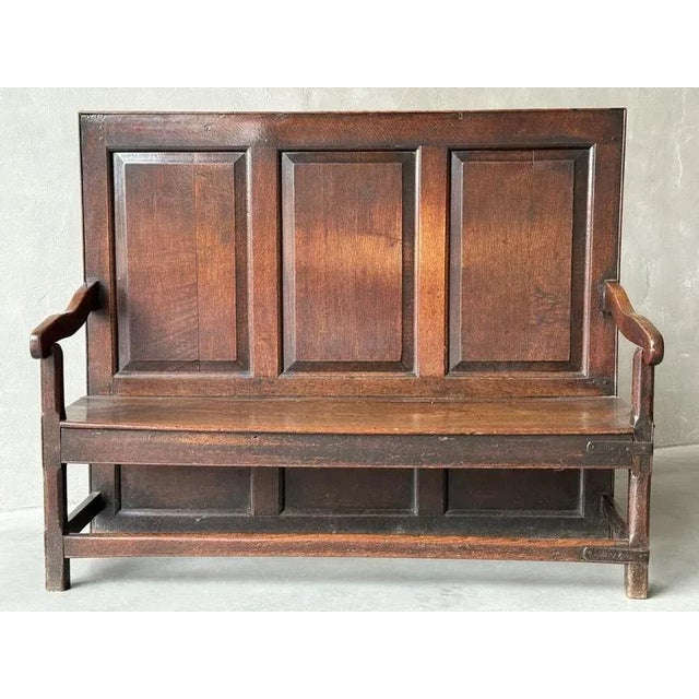 An C18th English Oak Panel back Settle with lovely old repairs. Of lovely colour and patina, this 'tavern' type bench has...