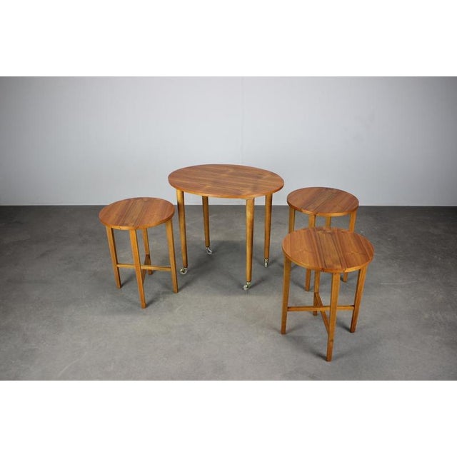 This Mid-Century Modern folding table with three nesting chairs was designed by Poul Hundevad in Denmark in the 1960s. A...