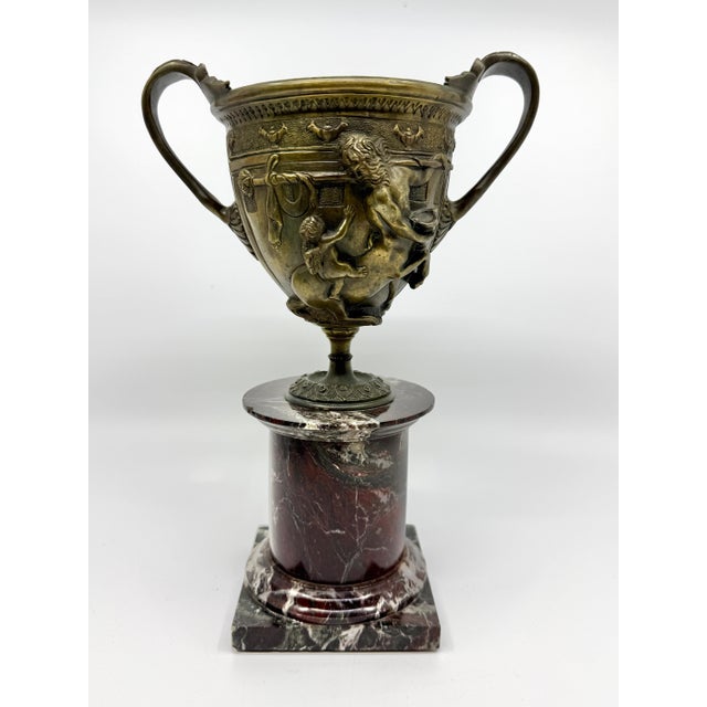 A wonderful pair of mated 19th century patinated Bronze relief Tazzas mounted on marble bases after the Pompeiian...