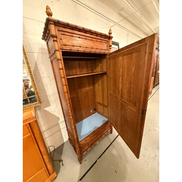Design Plus Gallery presents an R. J. Horner Style Victorian Faux Bamboo Pine Mirrored Armoire. This Victorian armoire...