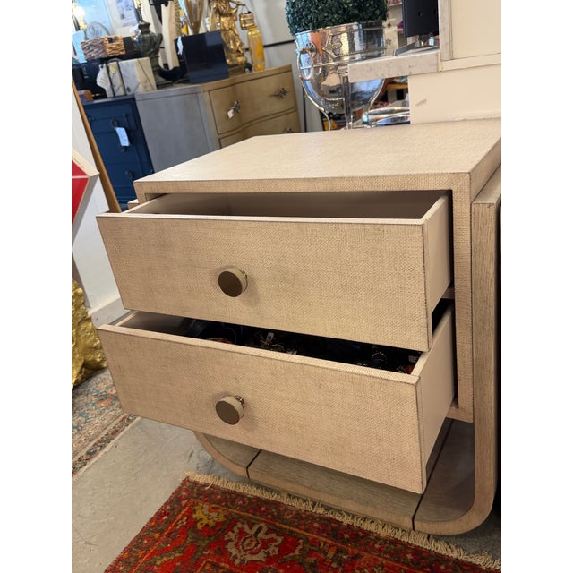 Pair of washed wood 2-drawer nightstands wrapped in linen and coated with a shellac. The drawers have rounded pulls in...