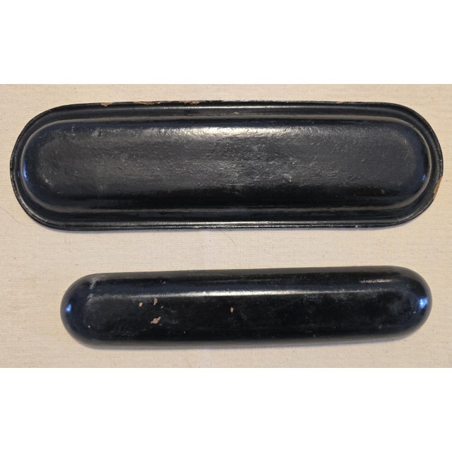 Smaller tray apears to be constructed of wood while the larger tray is constructed of a Papier-mâché core. The Period is...