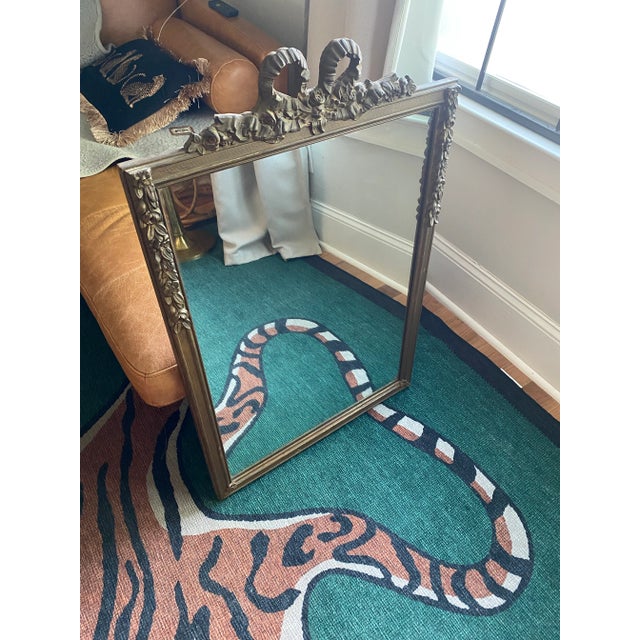 This stunning antique wall mirror dates to the 1920 and showcases exquisite French-inspired craftsmanship. The frame...