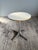 Designed by George Nelson for Herman Miller, this pedestal side table features a white laminate top on a cast aluminum...