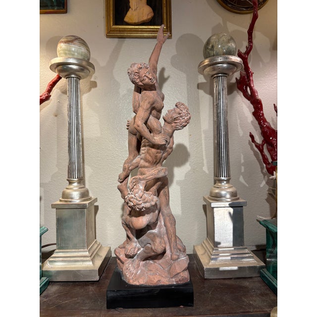 A classic Neoclassical revival, Grand Tour Italian terracotta-patinated reproduction of The Abduction of a Sabine Woman...