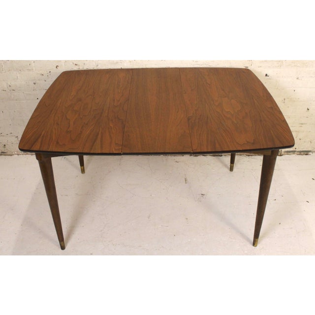 This is a stunning expanding walnut dining table by The Jefferson Wood Working Co.. This tables square shape and rounded...