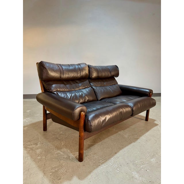Vintage 1970’s Scandinavian Loveseat styled after the Inca by Arne Norell. Outfitted in the original dark brown leather on...