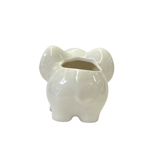 This is a set of 2 white base ceramic small planters in an open-top cute elephant shape. ( small hole at the bottom )...