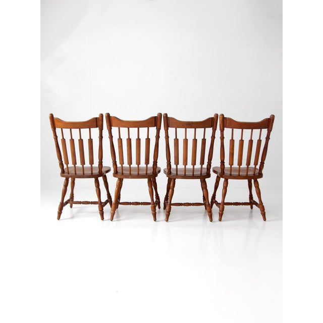 A set of four vintage Windsor dining chairs by Richardson Brothers, featuring classic spindle backs and gently curved...