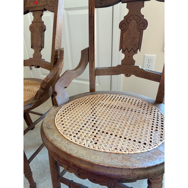 A set of four antique cane seat side chairs dating to the late 19th to early 20th century, likely of French Provincial or...