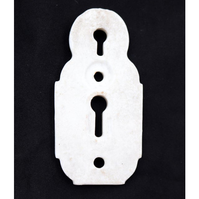 Vintage double keyhole white ceramic keyhole cover. The original mounting screws are not available. Good condition with...