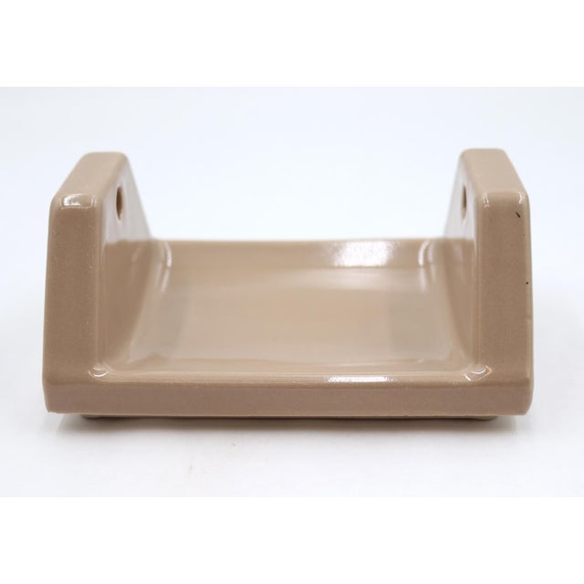 Vintage flush mount dark tan ceramic toilet paper holder with no roller. Old new stock - old but never used. Inscribed...