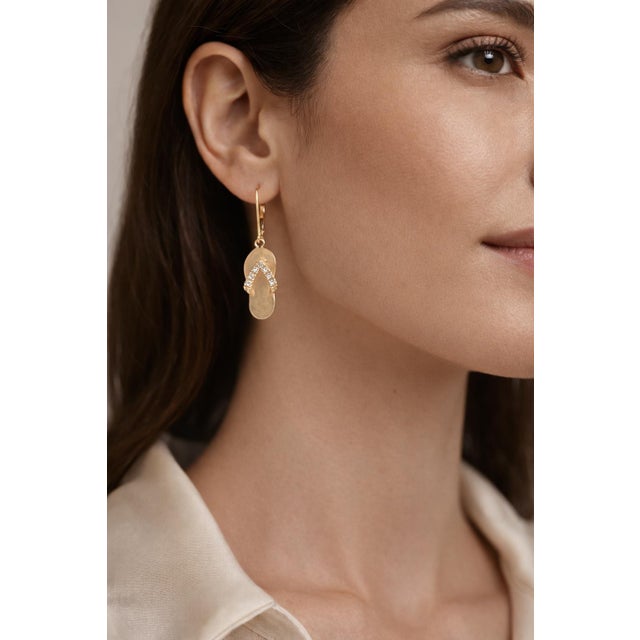 Charming Ha Hoku 14K yellow gold earrings designed as classic Hawaiian slippers, accented with sparkling diamonds. The...