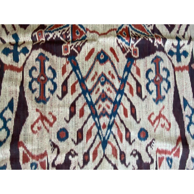 We added a bone suede border to this beautiful Sumba Hinggi ikat on one side. Mythical characters, lizards, horses and...