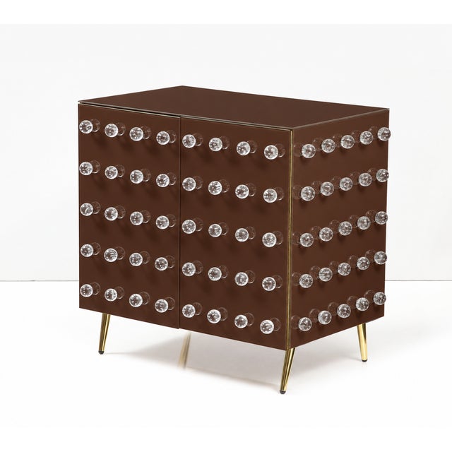 An italian contemporary cabinet made to order in a deep chocolate-brown finish, with 90 clear murano glass spheres across...