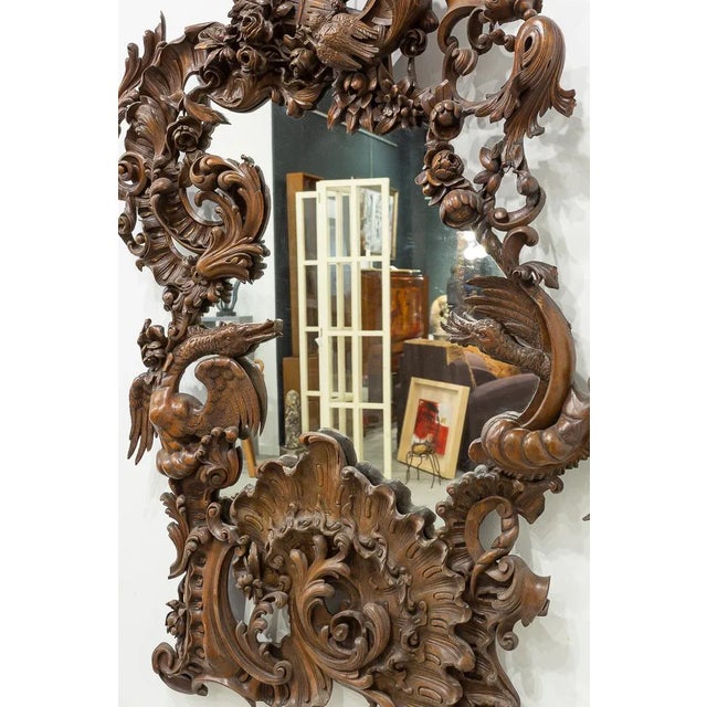 Irregular mirror with important carved wooden frame with fine design of fantastic repertoire of scallops, dragons, flowers...