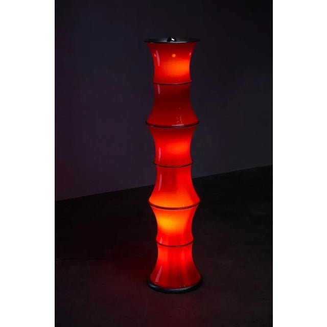 Presenting a stunning floor lamp inspired by bamboo aesthetics. Crafted with red glass forms separated by metal elements...