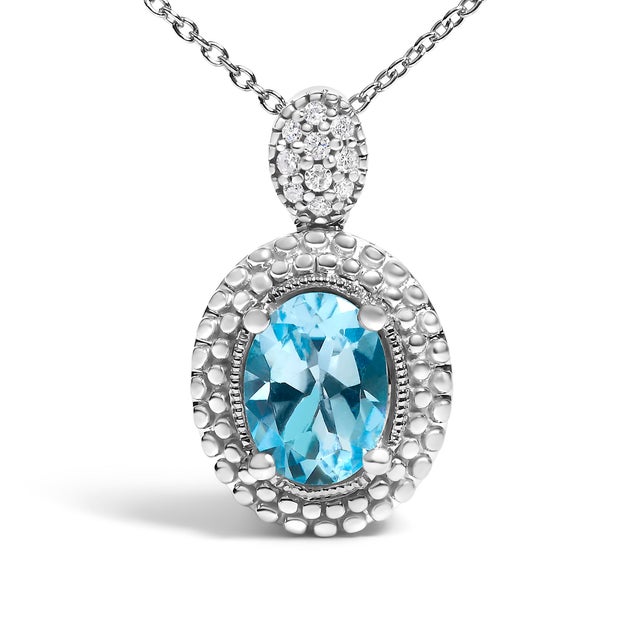 Draped in the timeless elegance of .925 sterling silver, this pendant necklace glimmers with a mesmerizing oval blue...
