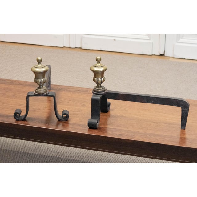 A decorative pair of French fireplace andirons, or fire dogs, dating from around 1920. Each piece is constructed from...