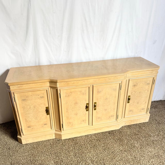 This exquisite Drexel Heritage Corinthian credenza showcases the timeless elegance of natural burlwood, celebrated for its...