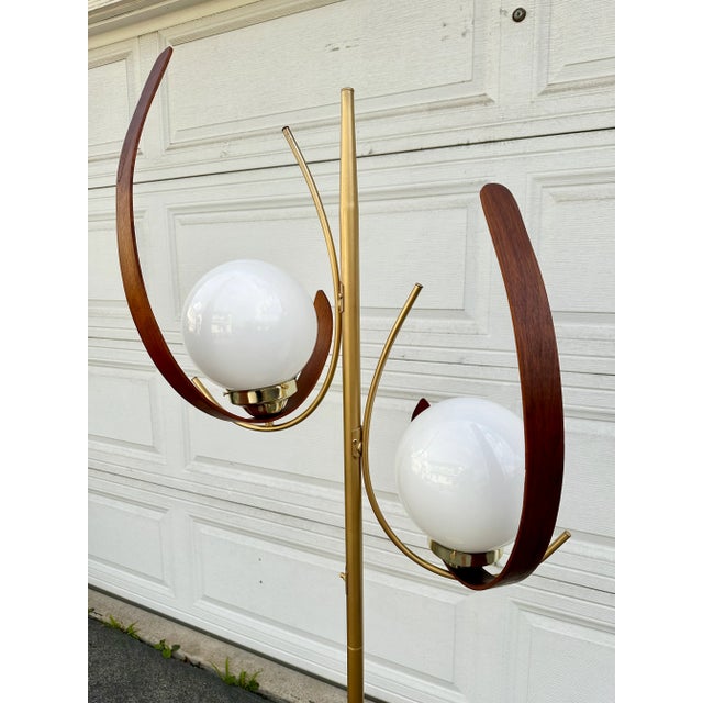 This is a one of a kind vintage mid century floor lamp with two 8” wide white globes. The accent crescent sculptural wood...