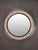 This circular wall mirror stands out for its opulent frame, composed of numerous faceted crystal prisms arranged in a...