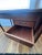 A beautifully constructed Danish modern teak executive desk featuring a drop leaf and a floating two-drawer cabinet....