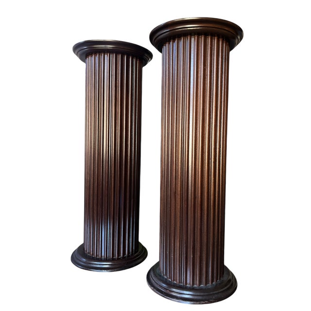 This striking pair of fluted wooden pedestals dates to circa 1992 and was made in the United States. Designed in a...