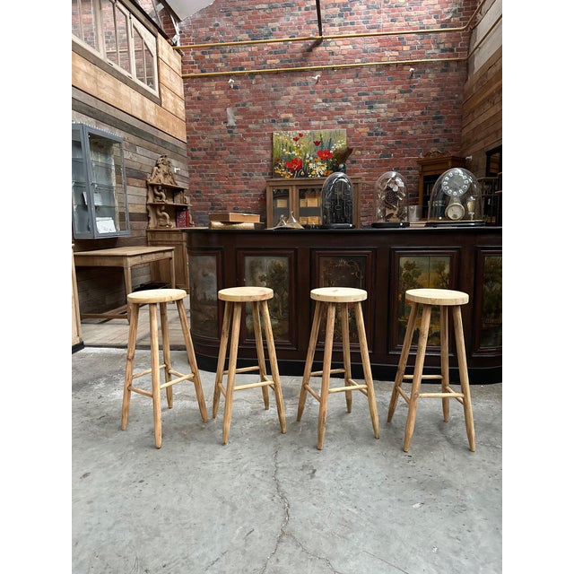 Set of 4 bar stools in raw pine dating from the 1980s Seat diameter 28 cm I have official proof of authenticity such as...