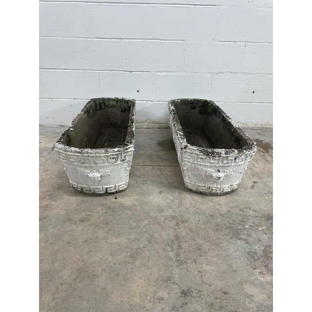 English garden, elongated planters of composite stone featuring a relief greek key and grape motif clusters around the...