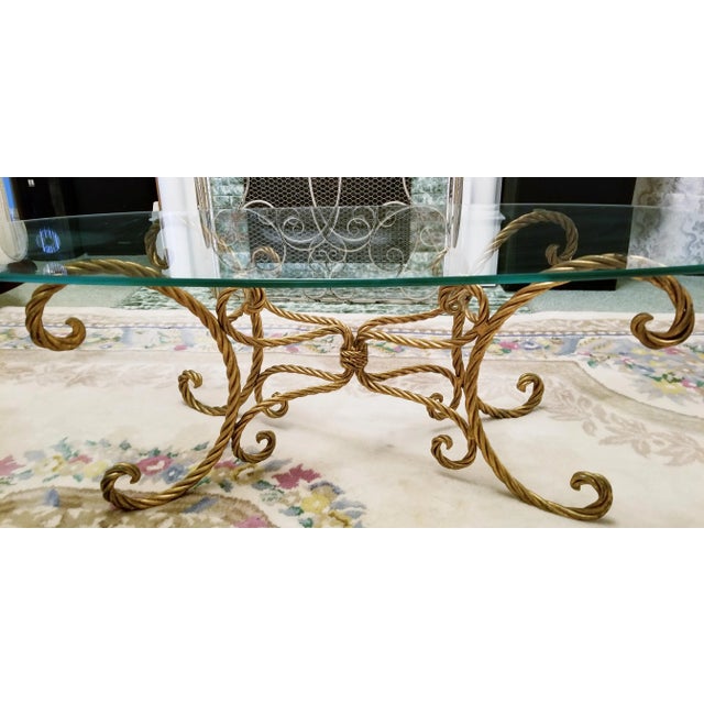 Fabulous vintage Italian gold rope and tassel coffee table with oval glass top. Still has original metal tag that reads...