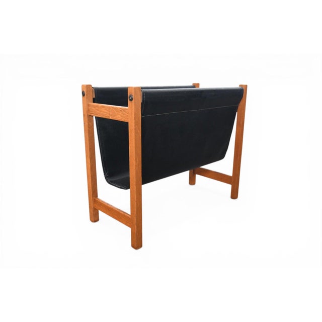 A sleek and functional magazine rack from Denmark, 1960s. Teak frame with black vinyl sling pockets — a great combination...