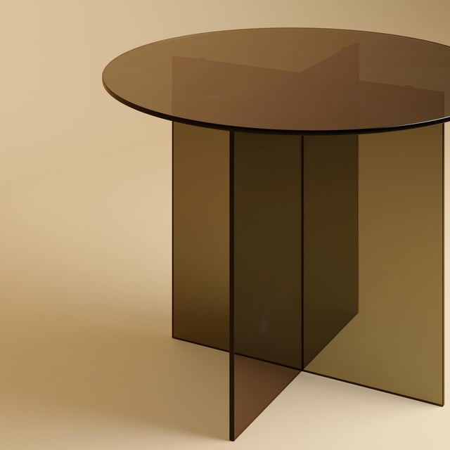 The Yuri is a bronzed glass dining table, a table scaled for a room and its company in which the material is also the...