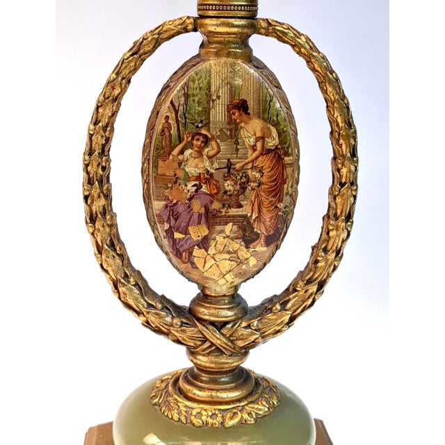 A beautiful pair of table lamps made of bronze with illustration on both sides and an onex stone at base. The switch is...