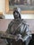Impressive patinated bronze statue of a figure in medieval attire holding a collection of bound scrolls. On the backside...