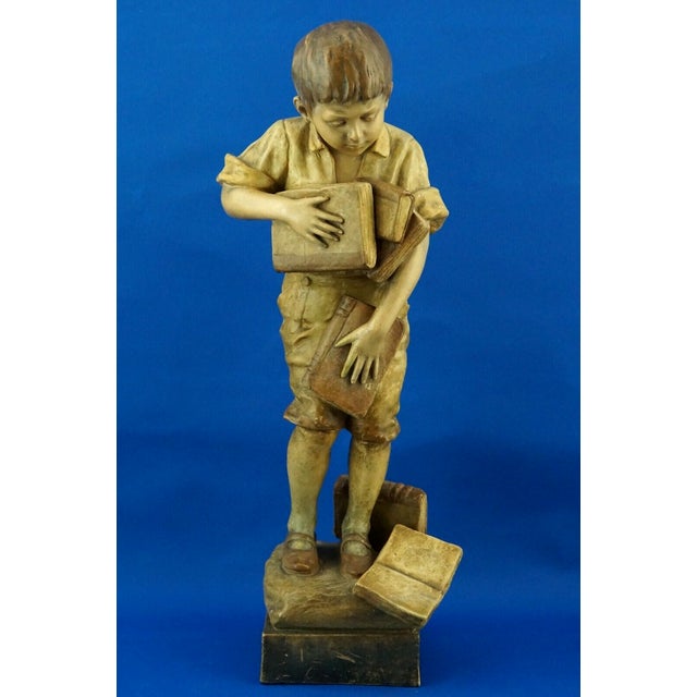 Fabulous, spectacular, large glazed terracotta sculpture depicting a child with books, created by the renowned artist and...