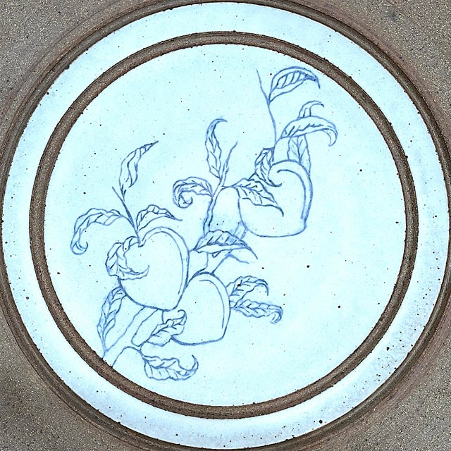 Extra large 1980's stoneware pottery charger. Its outer rim is lsaltglazed to refer the clay's natural characteristics. At...