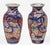 A small pair of Imari baluster shaped vases with flared necks decorated with boldly colored cobalt blue dragons, iron rust...