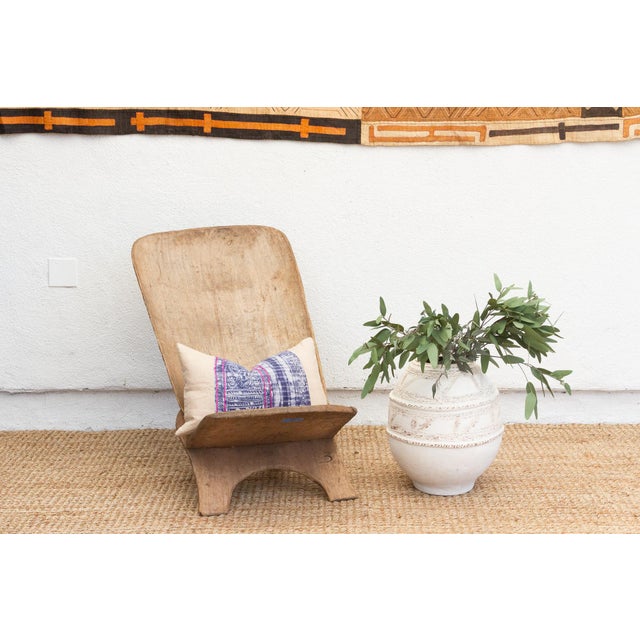 Experience the allure of West African craftsmanship with this unique hand-carved folding chair, often referred to as a...