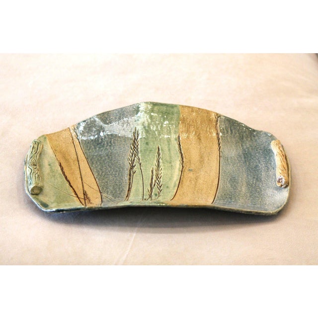 An excellent, one-of-a-kind pottery tray. Hand-made of clay in banded colors of muted green, blue and tan, it's incised...