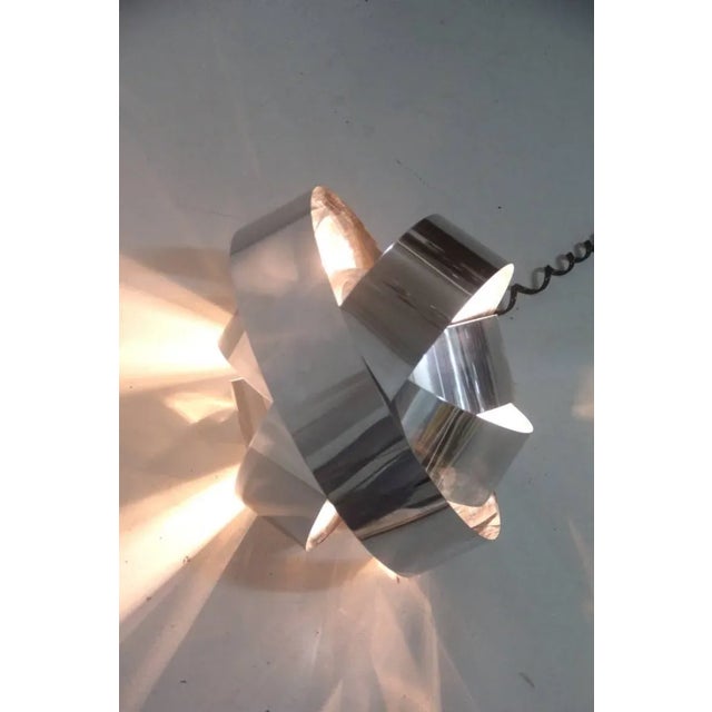 This vintage table lamp is in the style of Robert Sonneman and features curved steel. Up to 250V (Europe/UK Standard).The...