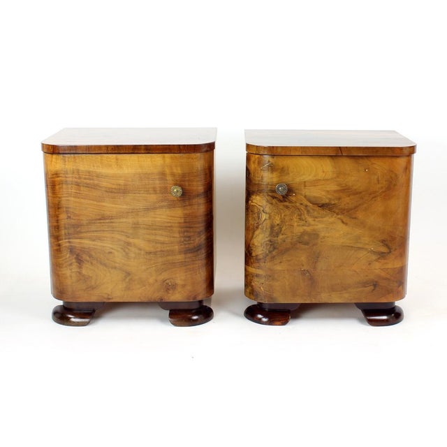 A refined pair of Art Deco bedside tables, produced in Czechoslovakia in the 1930s, showcasing the elegant craftsmanship...