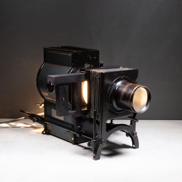 ABOUT An antique Bausch & Lomb magic lantern slide projector with original metal carrying case. This industrial-era...
